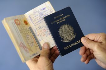 Duas mãos segurando dois passaportes