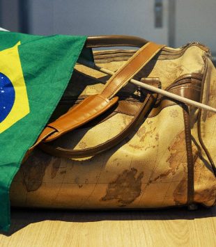 Mala com uma bandeira do Brasil enrolada - brasileiros famosos que estudaram fora